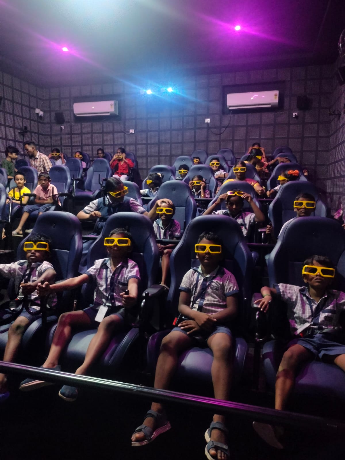 Children watching an educational 3D film on a class outing