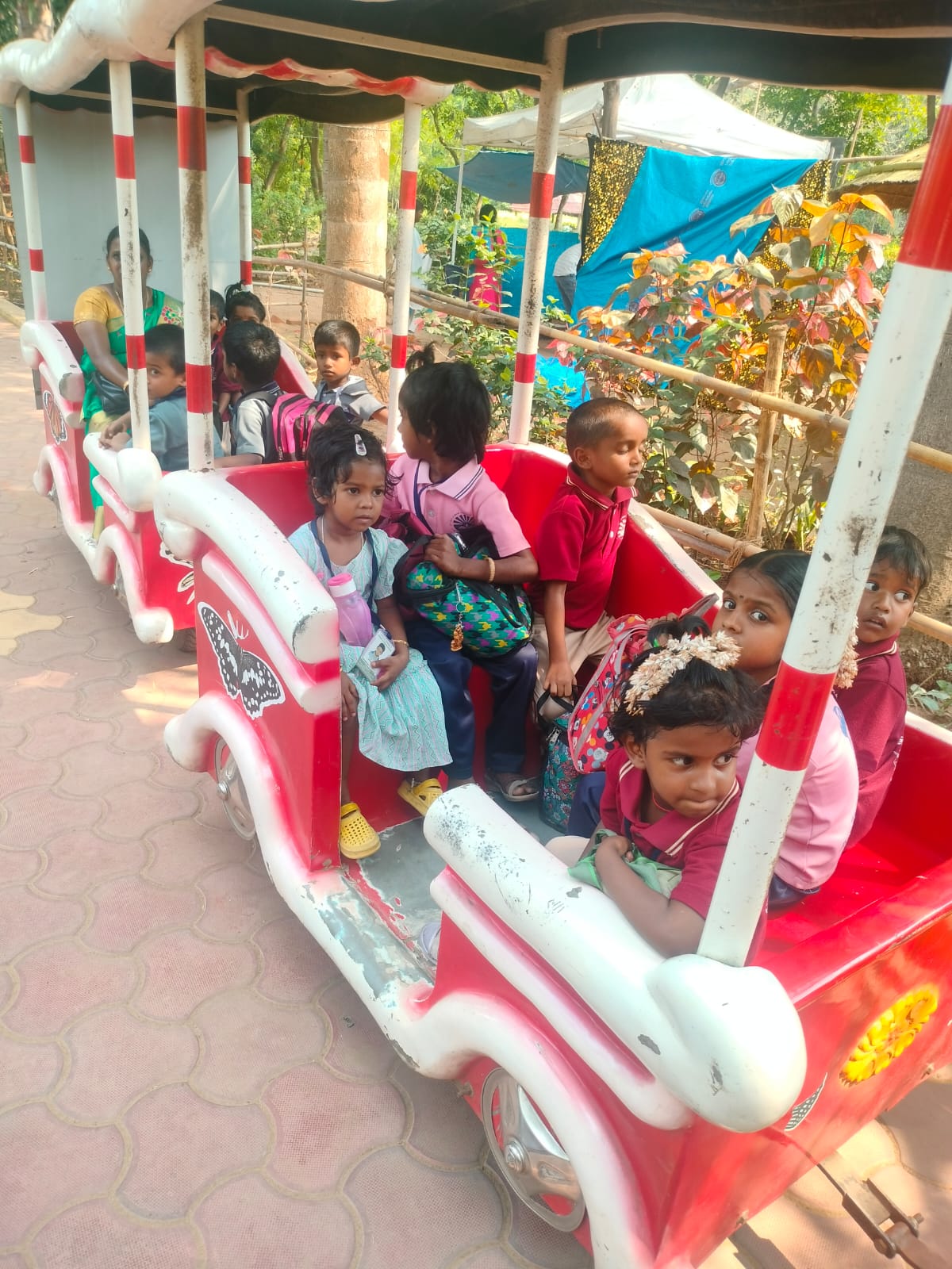 Children enjoying a toy-train ride on a field trip